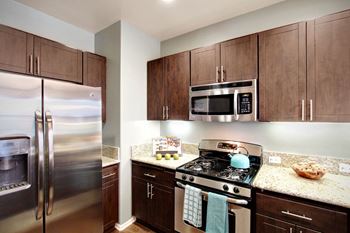 a kitchen with stainless steel appliances and granite counter tops at The Vines at Riverpark, LLC, Oxnard, CA 93036